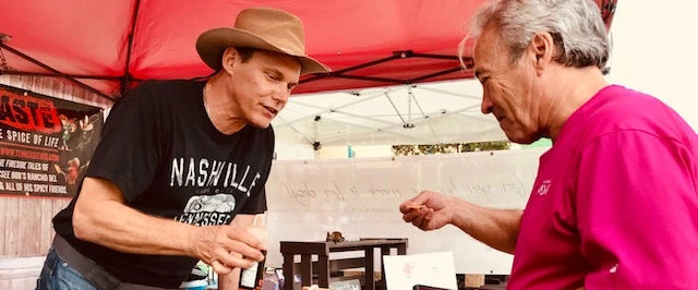Bob in the markets tasting hot sauces