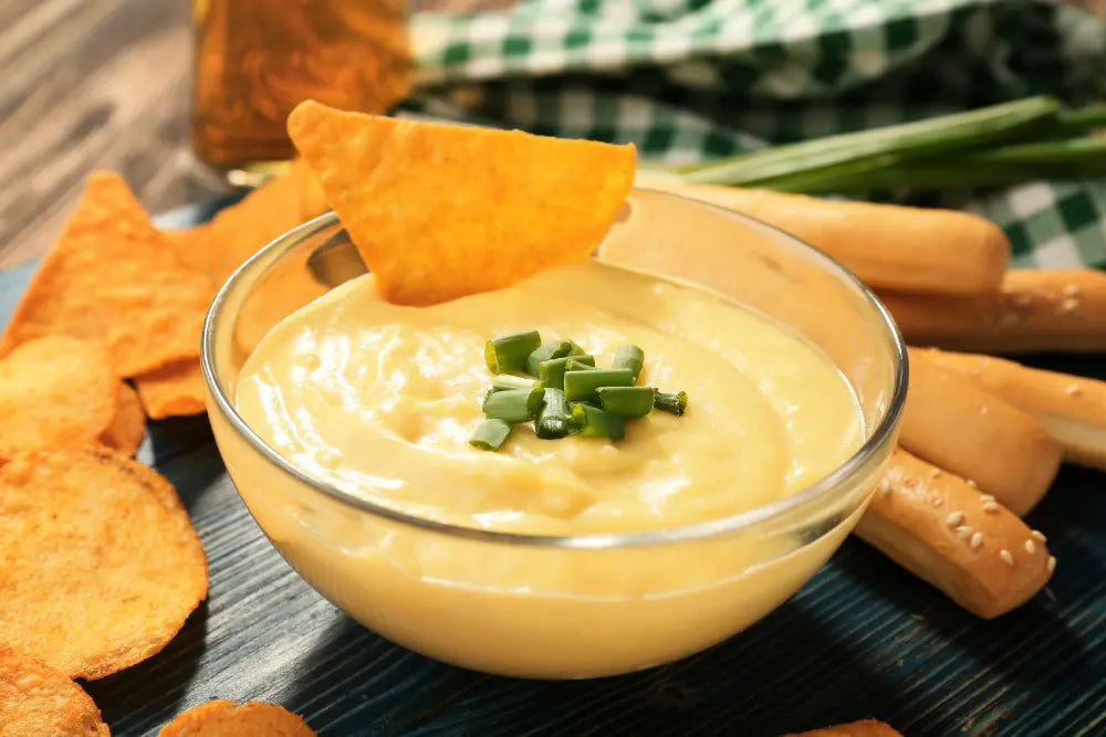 Tennessee Bob's Queso Dip with Happy Habanero Hot Sauce, cilantro, and pomegranate seeds