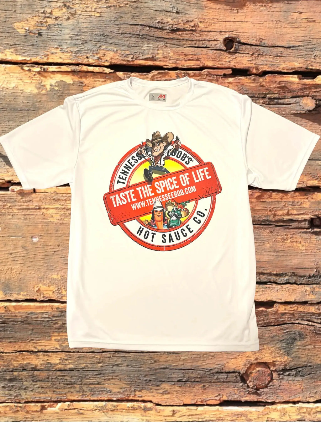 White t-shirt with a red and yellow logo on a wooden surface