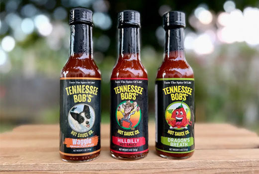 Tennessee Bob's hot sauce bottles: Waggie, Hillbilly, Dragon's Breath, spicy condiments, three flavors.