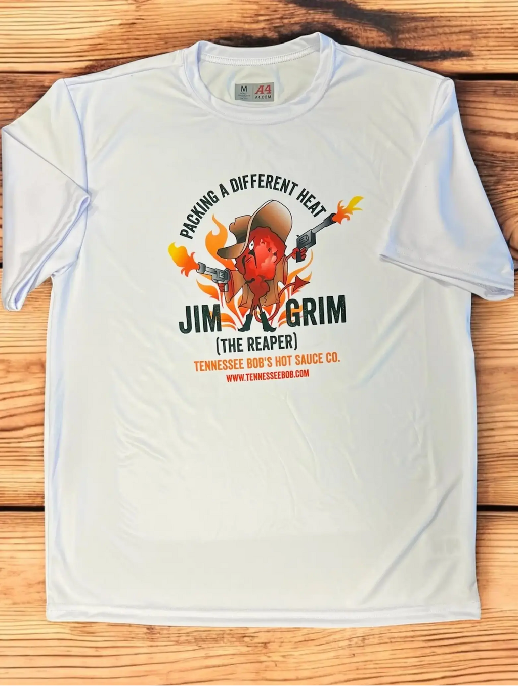 White t-shirt with a cartoon chili pepper character holding guns, featuring "Jim Grim" branding and slogan.